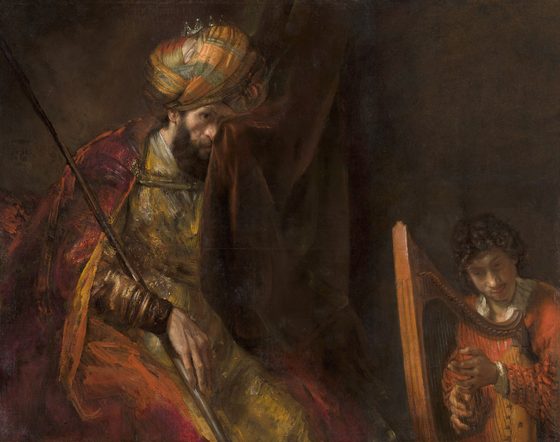 King Saul, spear in hand, wipes his eye with a curtain while young David plays the harp beside him