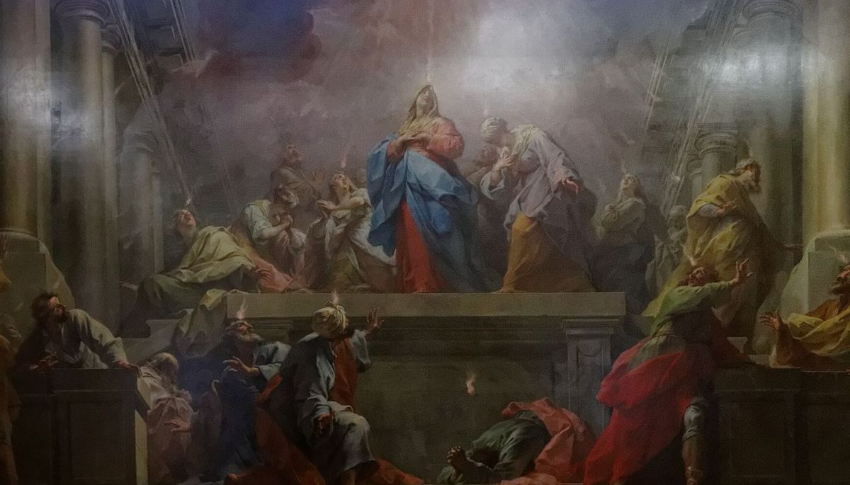 Tongues of fire descend on Mary and the apostles gathered in a great hall