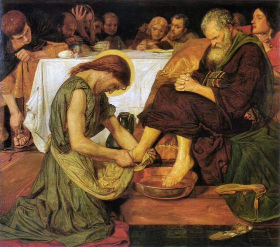 Jesus kneels to wash Peter’s feet while the other disciples look on