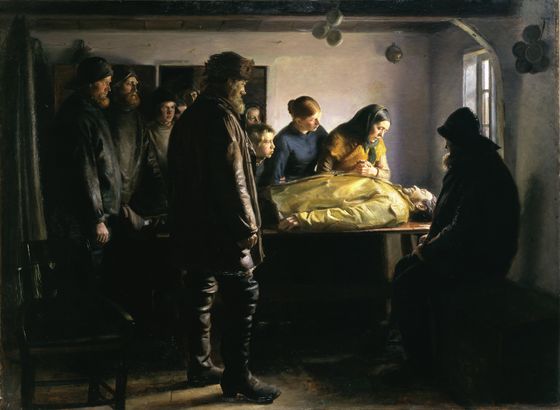 Fishermen in their hats stand around a drowned comrade laid on a table under an oilskin, as two women bend over him