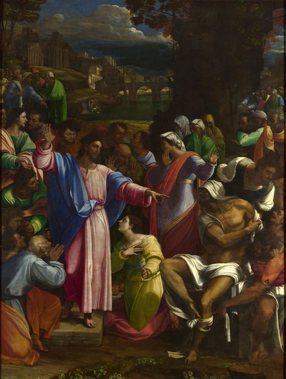 Christ points to Lazarus rising from the tomb while a woman kneels at Christ's feet among the crowd