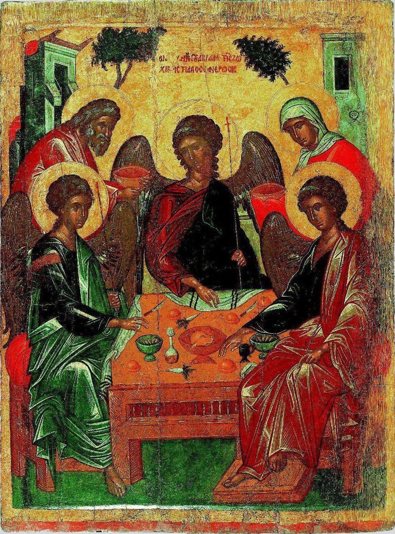 A Greek icon on a gold ground: three winged angels with haloes sit at a red table set with cups and bread. Behind them, at the top left, Abraham, grey-bearded, carries a dish, and at the top right Sarah, in a red veil, brings another. A tree and two buildings stand behind.