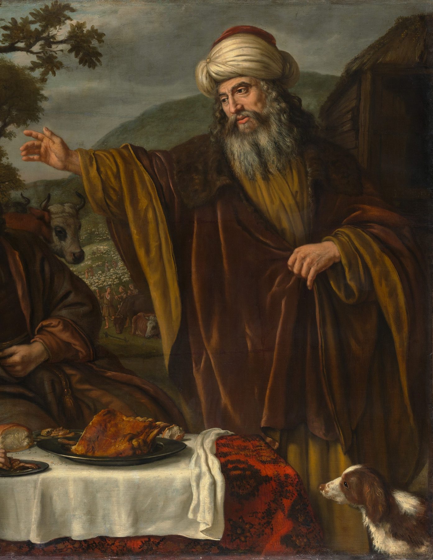 A painting by Jan Victors: Abraham, an old man with a long grey beard, wears a cream turban with a red crown and a heavy brown cloak lined with gold. He stretches his right hand out toward the open country behind him, where cattle graze below green hills. In front of him a meal is laid on a white cloth, and a brown and white dog looks up at him.