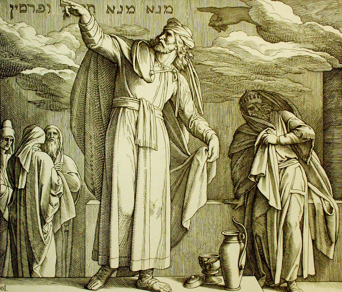 A woodcut by Julius Schnorr von Carolsfeld: Daniel, bearded and turbaned, in a long robe, stands tall and points up at words in Hebrew letters written high on the wall, where a pointing hand comes out of the clouds. At the right, King Belshazzar hides his face in his cloak. Wise men huddle at the left, and a jug and cups stand on the floor.