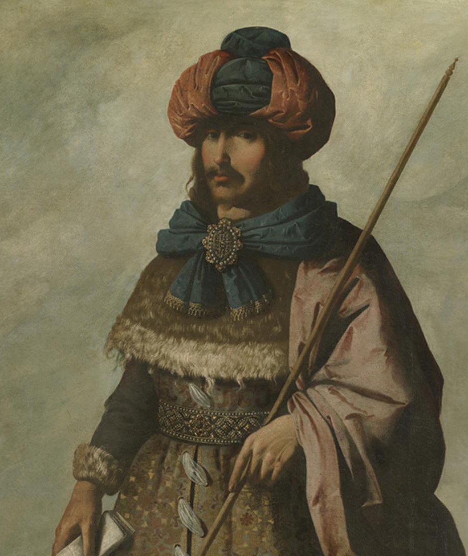 A painting by Zurbarán: Joseph as a bearded man in a tall red and green turban, a blue scarf pinned with a jewel at his throat, a fur-trimmed brocade coat and a rose cloak. He holds a long staff and a folded paper.