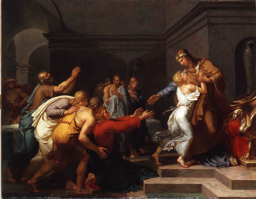 A painting by Girodet: in a dark stone hall, Joseph, in a brown cloak and a gold headband, stands at the top of the steps and holds young Benjamin, fair-haired and in white, against his chest. With his other hand he reaches out to his brothers, who crowd up the steps toward him from the left, kneeling, weeping and raising their arms.