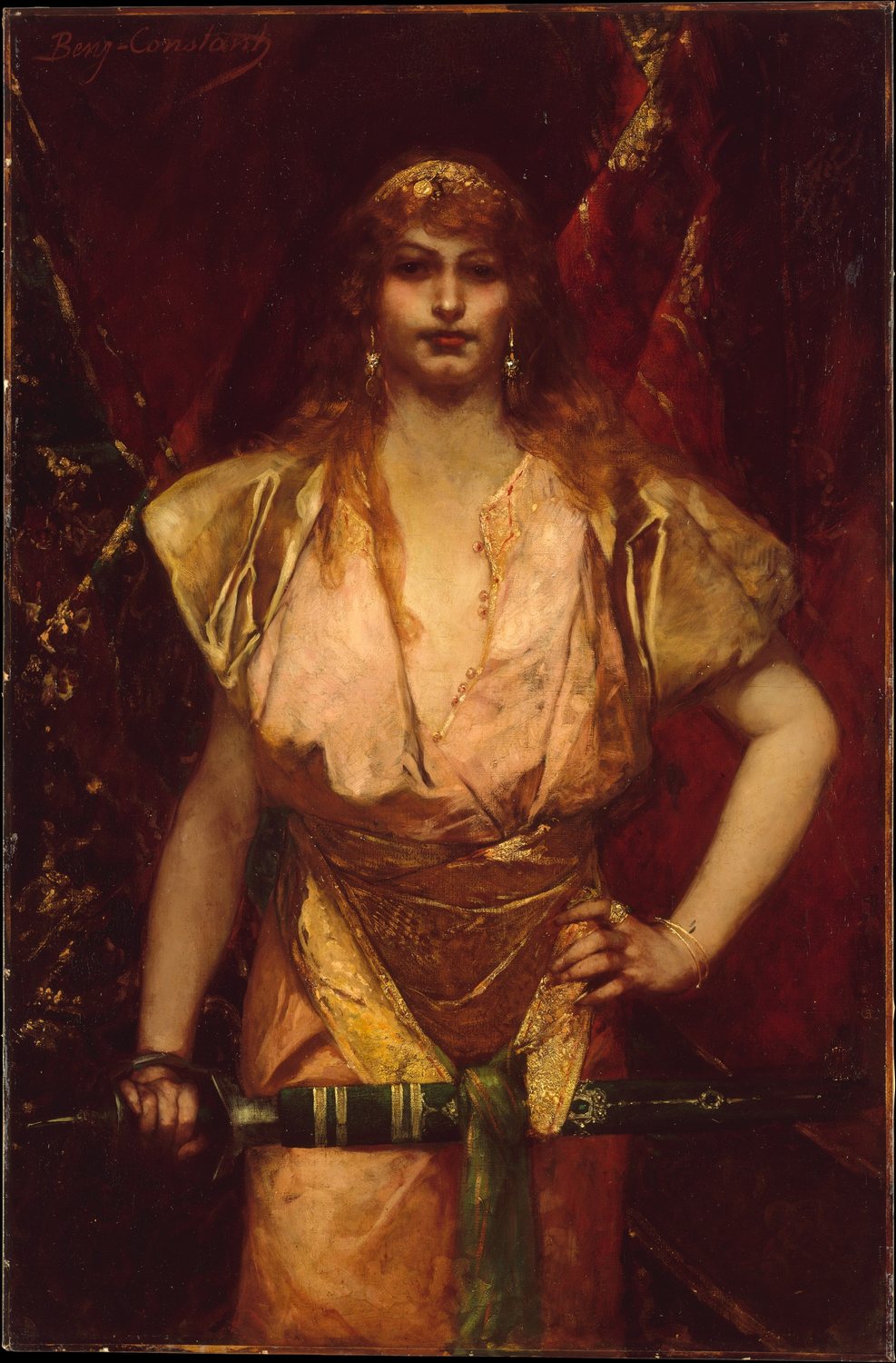 A painting by Benjamin-Constant: Judith stands facing us before deep red curtains, with a steady, unsmiling gaze. Her long red-gold hair falls loose under a gold band. She wears a pale silk gown with a gold sash, one hand on her hip, and holds a sheathed sword across her body.