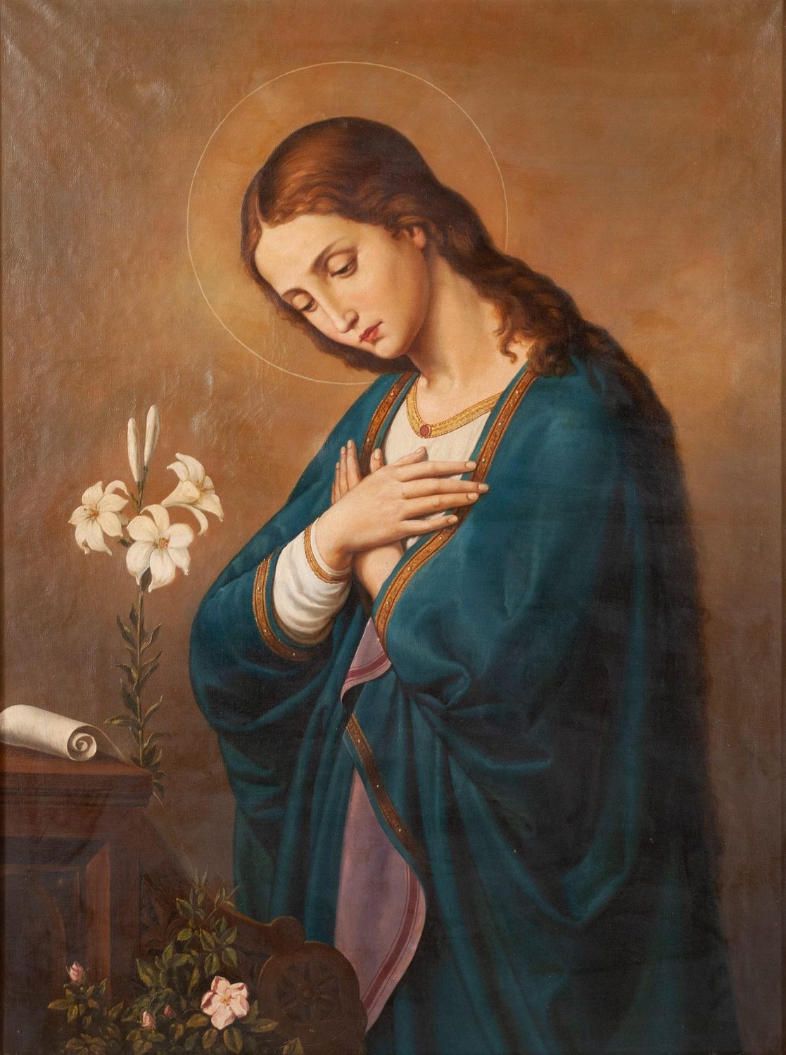 An oil portrait: Mary, with a thin gold halo and long brown hair, bows her head and lays her right hand on her breast. She wears a red gown under a deep blue mantle, and white lilies stand beside her.