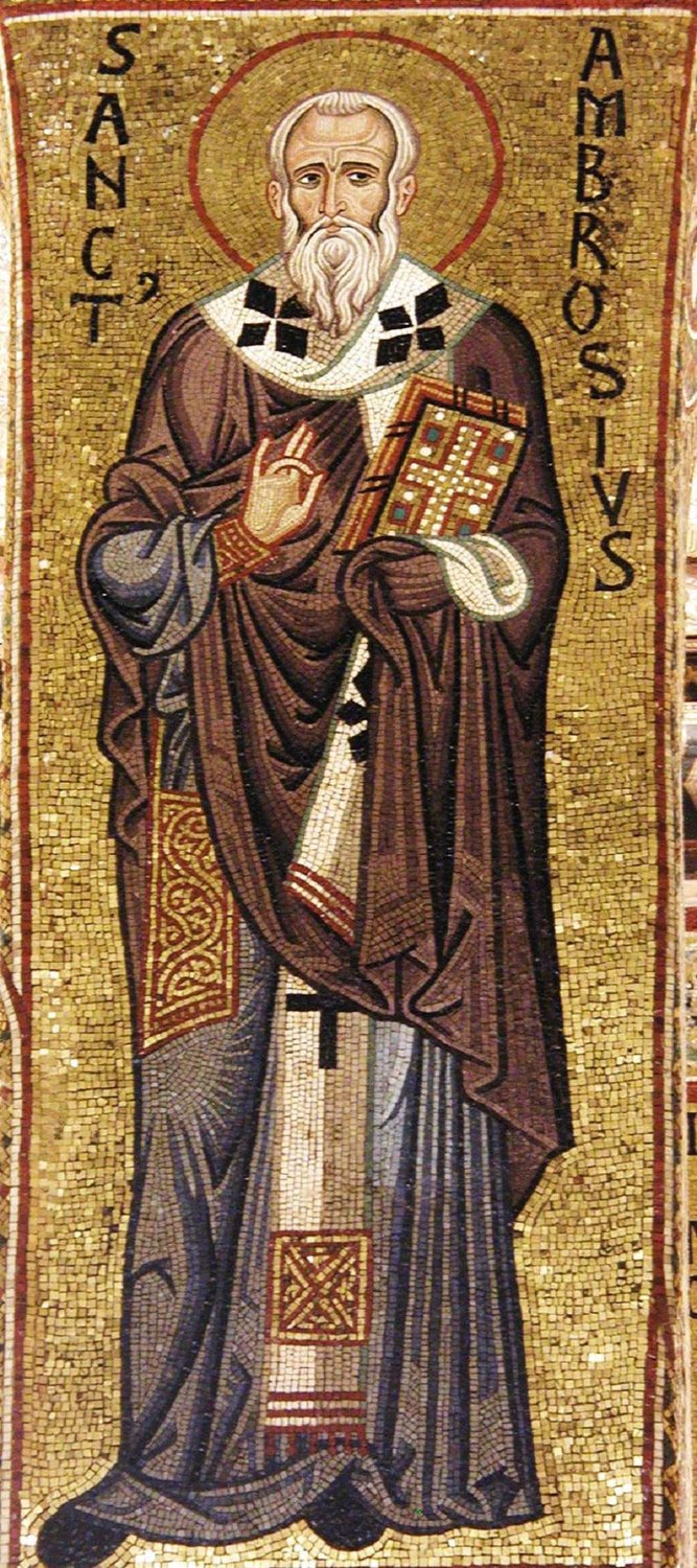 A mosaic on gold: Ambrose stands full length, white-haired and bearded, in a brown cloak over a white stole marked with black crosses. He raises his right hand in blessing and holds a jewelled book, and his Latin name is set in the gold on either side of him.