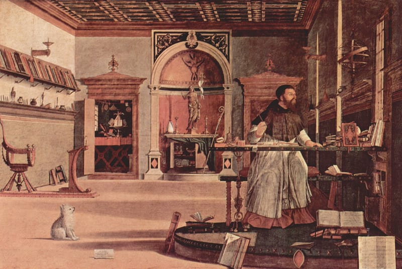 A painting: Augustine, bearded, in a black cap and a white robe over a dark habit, sits at a desk in a large study, pen raised, looking up towards the light from a window. Books and papers lie around him, and a small white dog sits on the floor watching him.