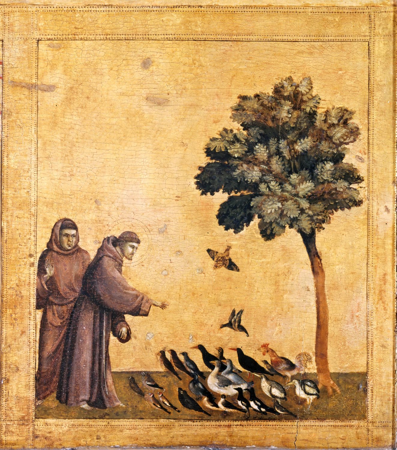 A small gold-ground panel: Francis in a brown habit leans toward a crowd of birds on the grass beneath a tree, while a second friar stands behind him