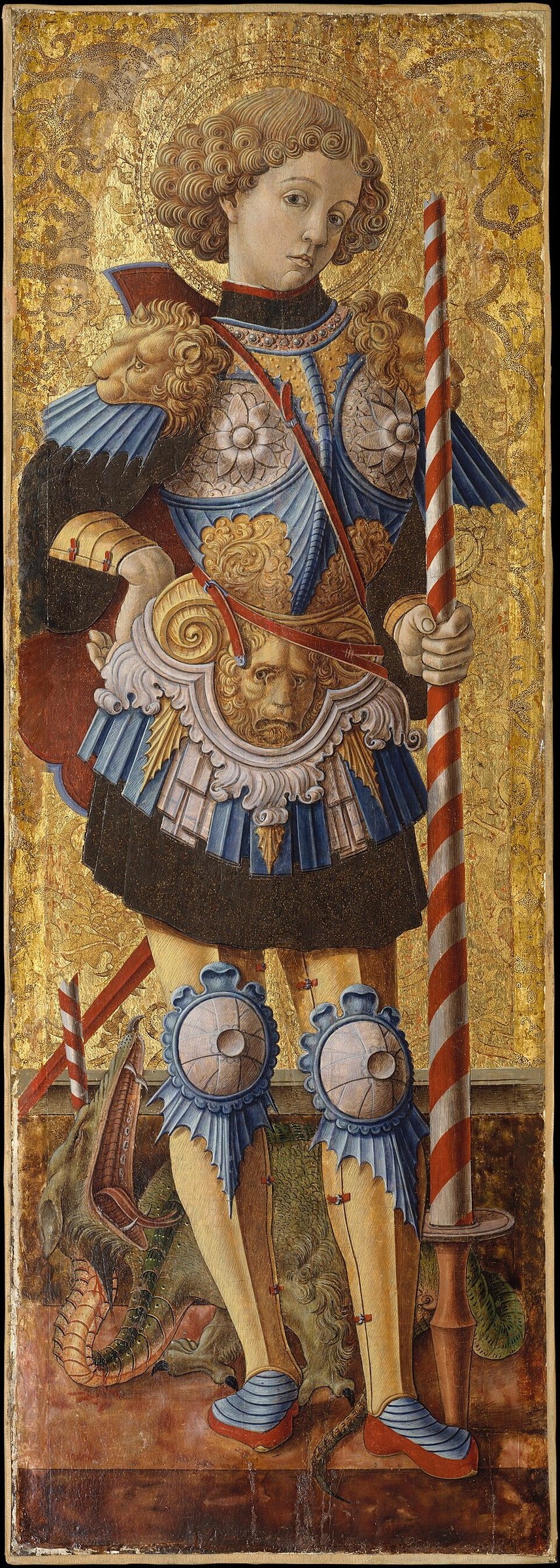 An Italian panel painting on a gold ground: George, young, with a mass of tight golden curls and a halo, stands in fanciful blue and silver armour with lion-head shoulder guards, holding a broken lance striped red and white, the dead dragon at his feet.