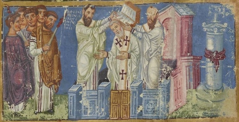 A Byzantine miniature on a deep blue ground: two bishops hold an open Gospel book over the head of grey-bearded Gregory, who stands between them in a white stole marked with crosses. Clergy look on from the left, one holding a candle, and a pink church and a column stand on the right.