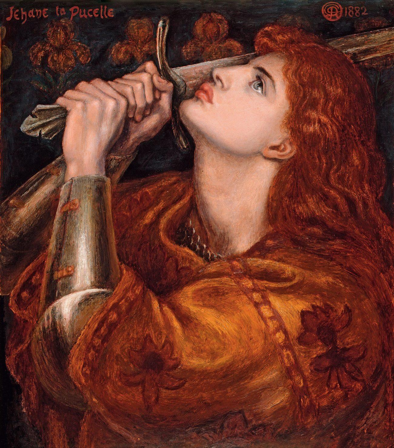A painting: Joan, with long red-gold hair and a golden-brown robe over armour, lifts her face and kisses the hilt of a sword held upright before her, lilies on the dark wall behind, and the words Jehane la Pucelle in the corner