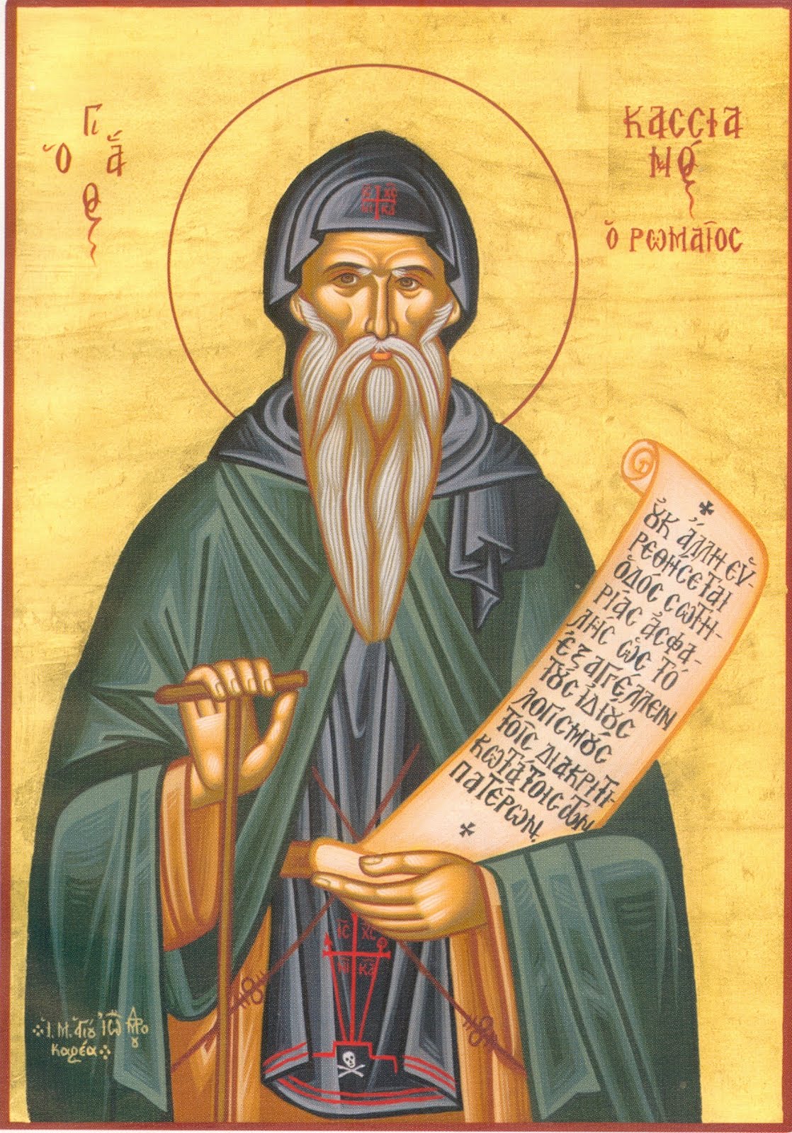 A Greek icon on gold: Cassian as an old monk with a long white beard, in a dark hood and a green mantle. He leans on a staff and holds an open scroll of Greek writing, and his name is lettered beside his halo.