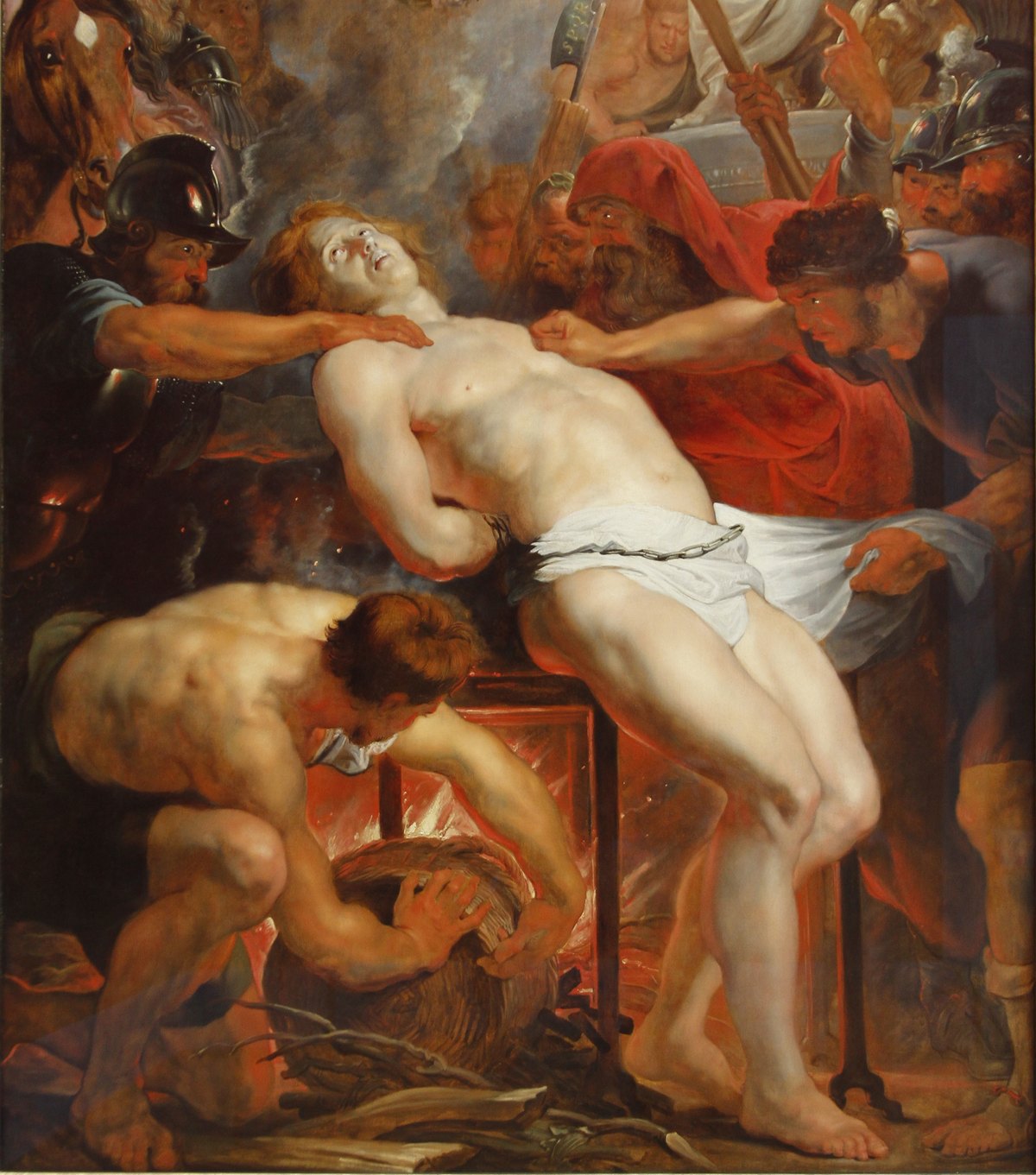 A painting by Rubens of the martyrdom of Lawrence: the young deacon, stripped to a white cloth, is held down on a gridiron over glowing coals by muscular executioners, one stooping to stoke the fire, while soldiers and a horse crowd in at the left