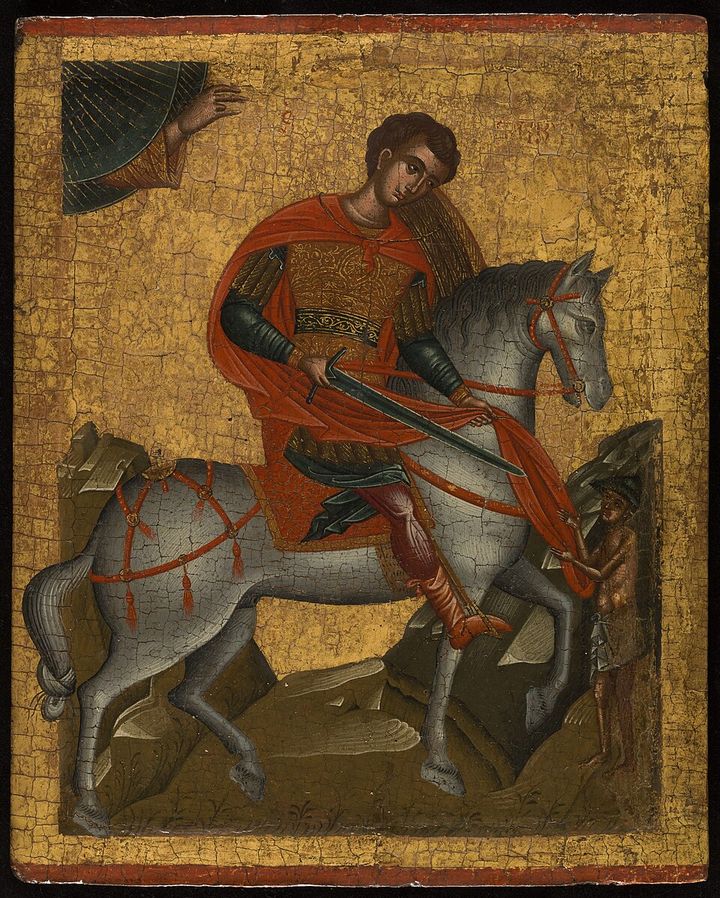 An icon on gold: the young Martin on a grey horse cuts his red cloak with a sword for a beggar, while the hand of God reaches down from the corner