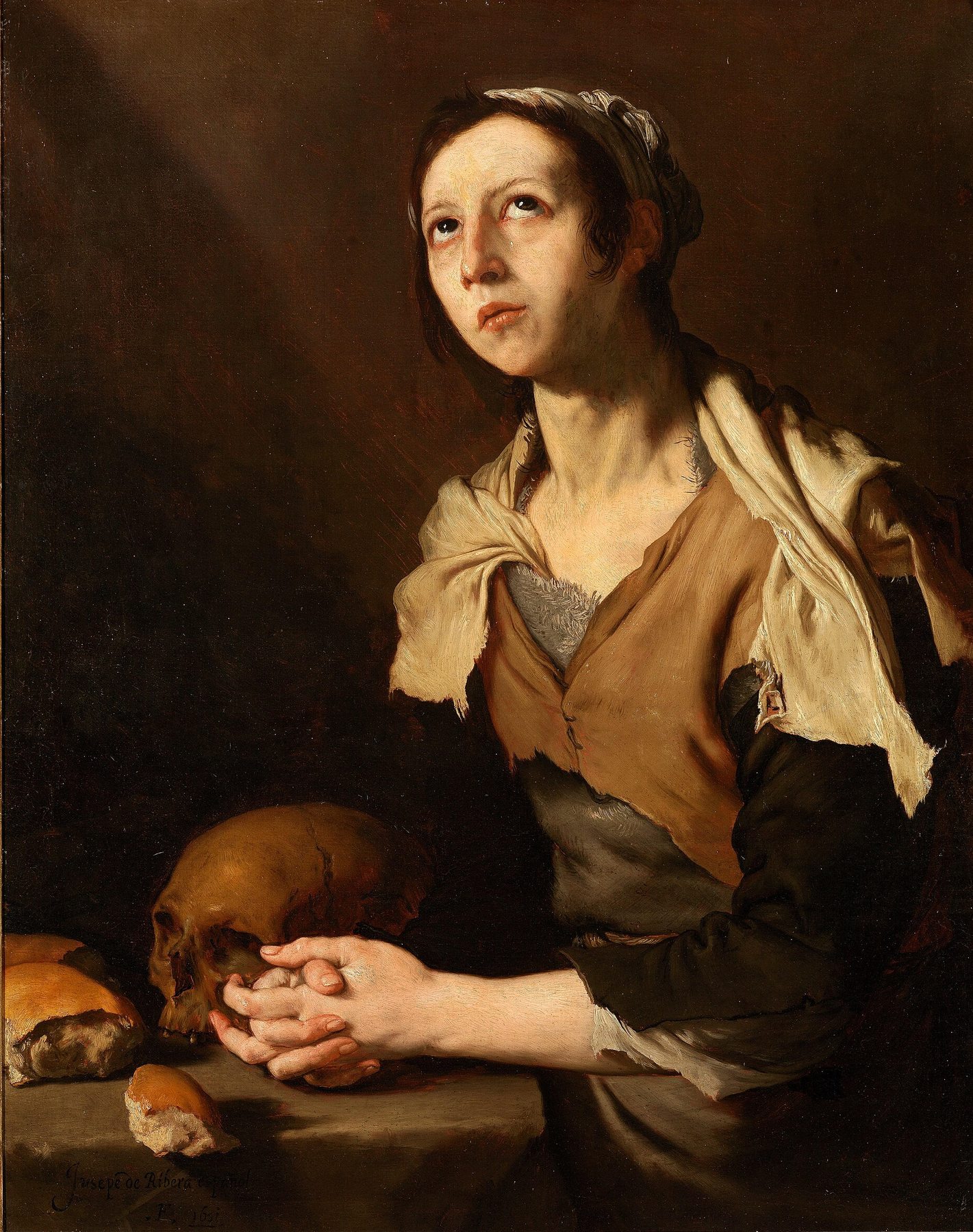 A young woman in a brown bodice, a torn cream shawl and a white headscarf looks up with wet eyes, her hands clasped on a stone ledge beside a skull and two loaves of bread, against a dark background
