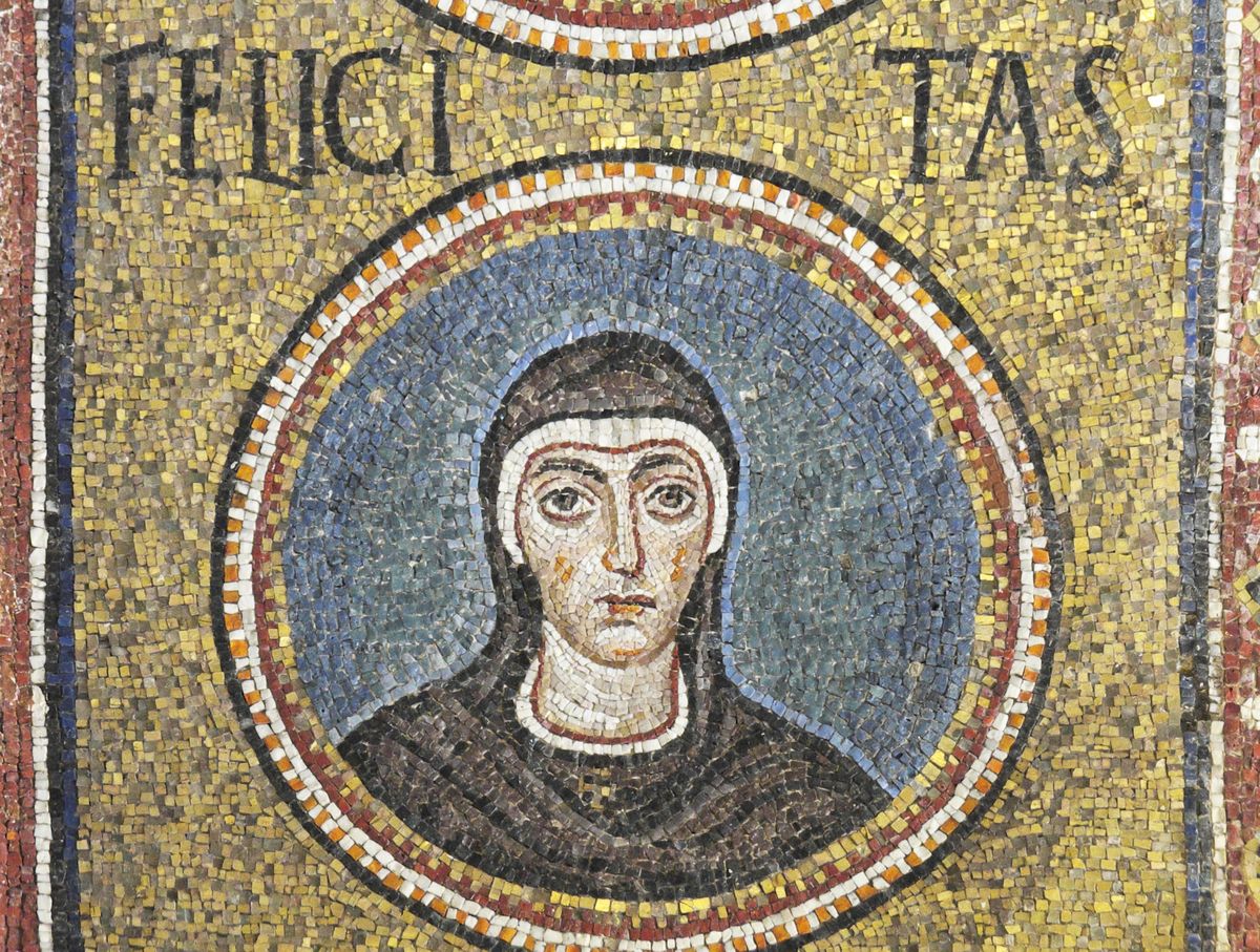 A mosaic medallion of Saint Felicity: a young woman with large dark eyes, in a dark brown veil and cloak, against a blue ground in a gold field. Her name, FELICITAS, is set in the gold above her.